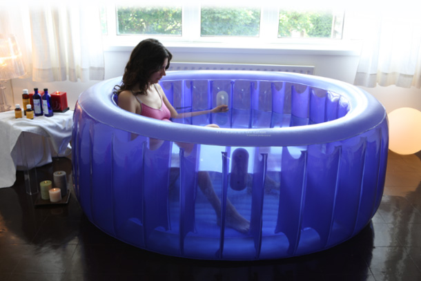 A woman sitting in a birthing pool at home
