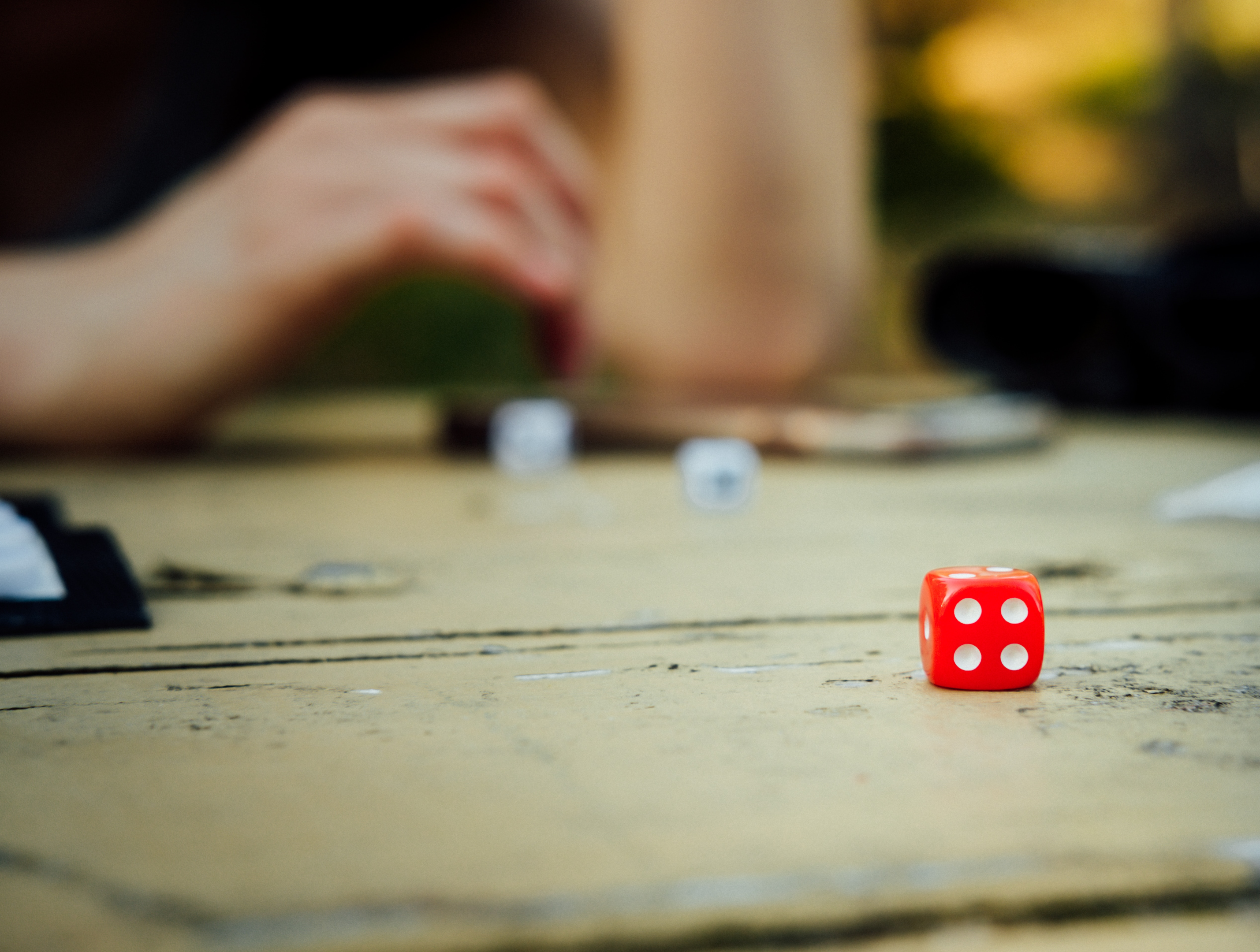 A red die on a board game. Photo by Tim Foster on Unsplash