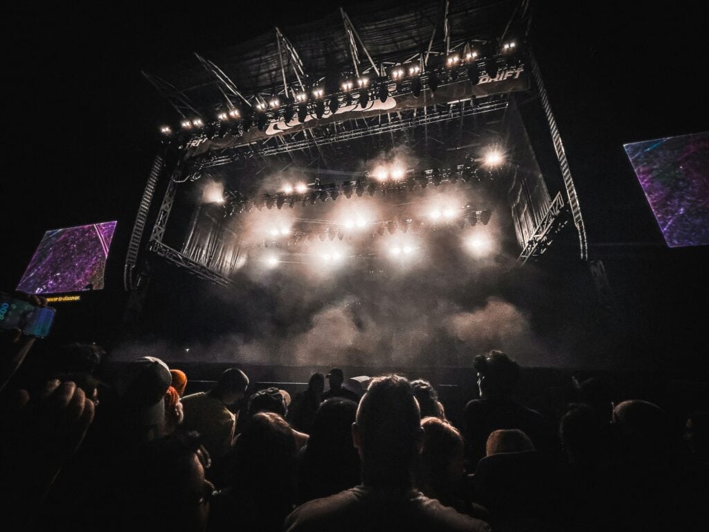 Bright lights on a festival stage. Photo by Terrah Holly on Unsplash