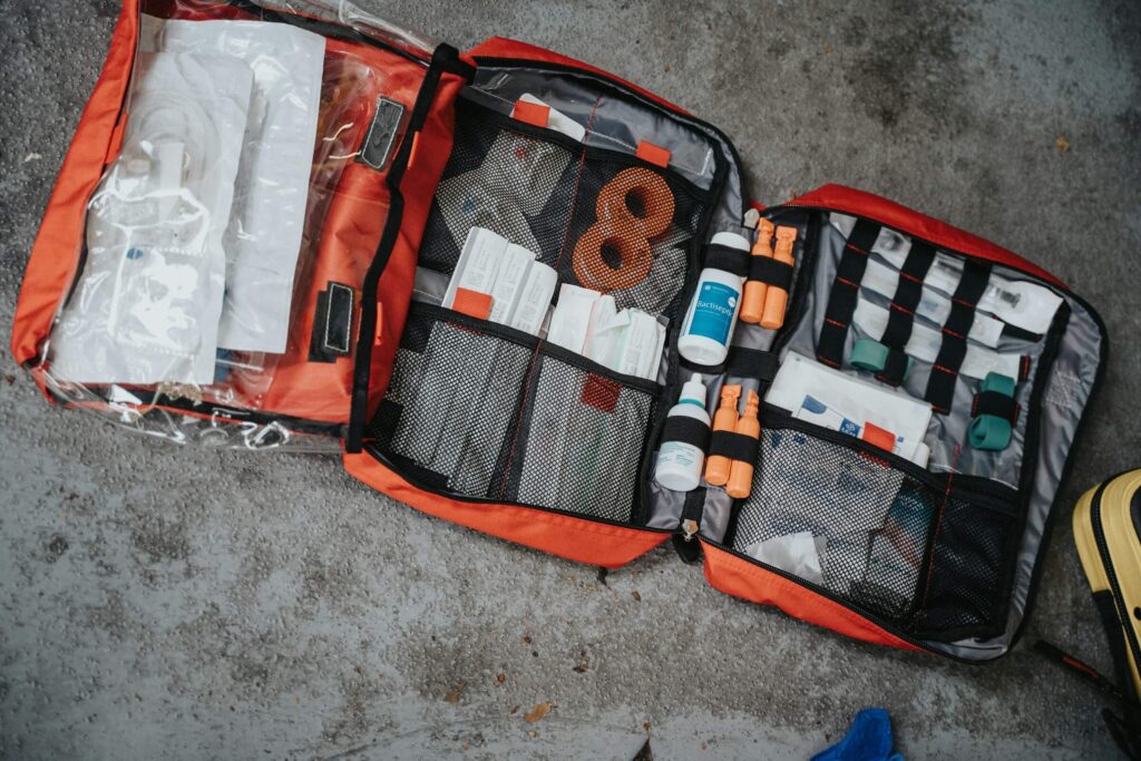 An open first aid kit bag. Photo by Scott Goodwill on Unsplash