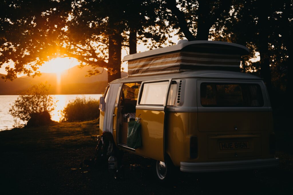 A campervan near water. Photo by Kevin Schmid on Unsplash