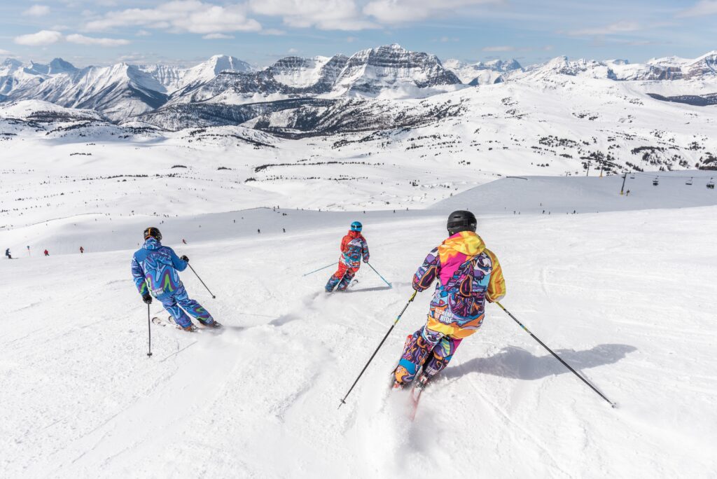 Three people skiing. Photo by Banff Sunshine Village on Unsplash