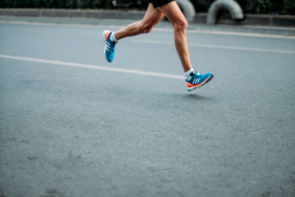 Someone running on the road. Photo by sporlab on Unsplash