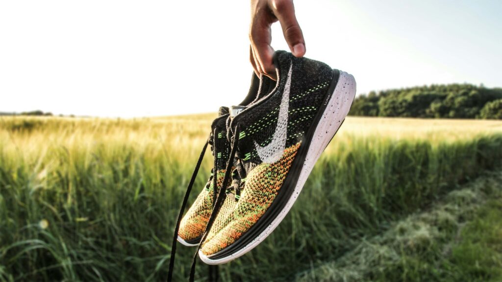 Someone holding trail running shoes. Photo by Kristian Egelund on Unsplash