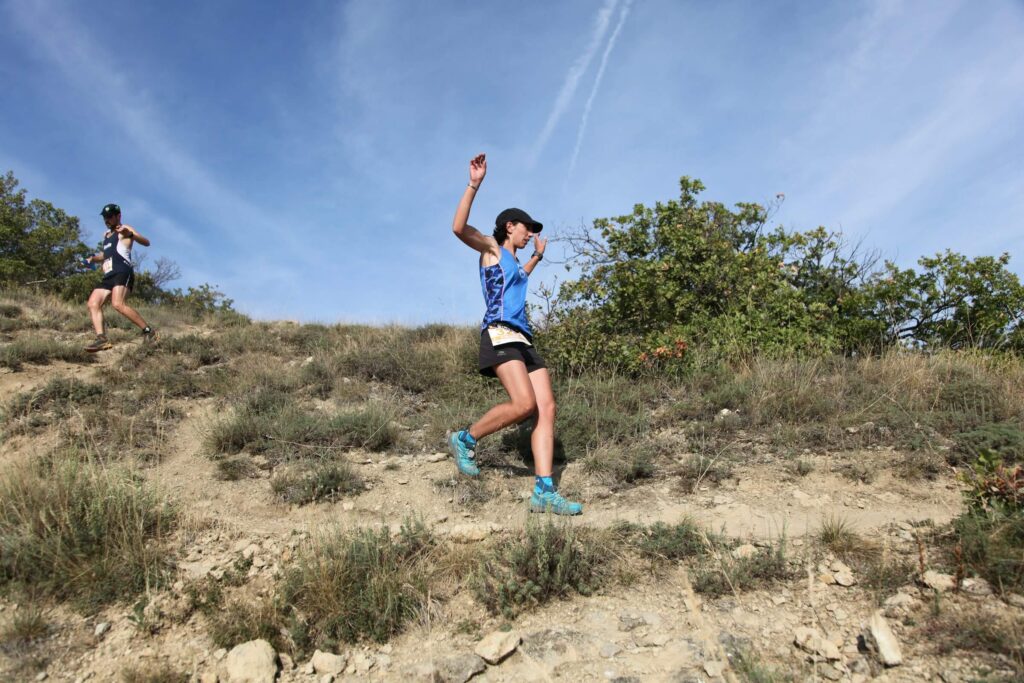Someone running along a trail path. Photo by Massimo Sartirana on Unsplash