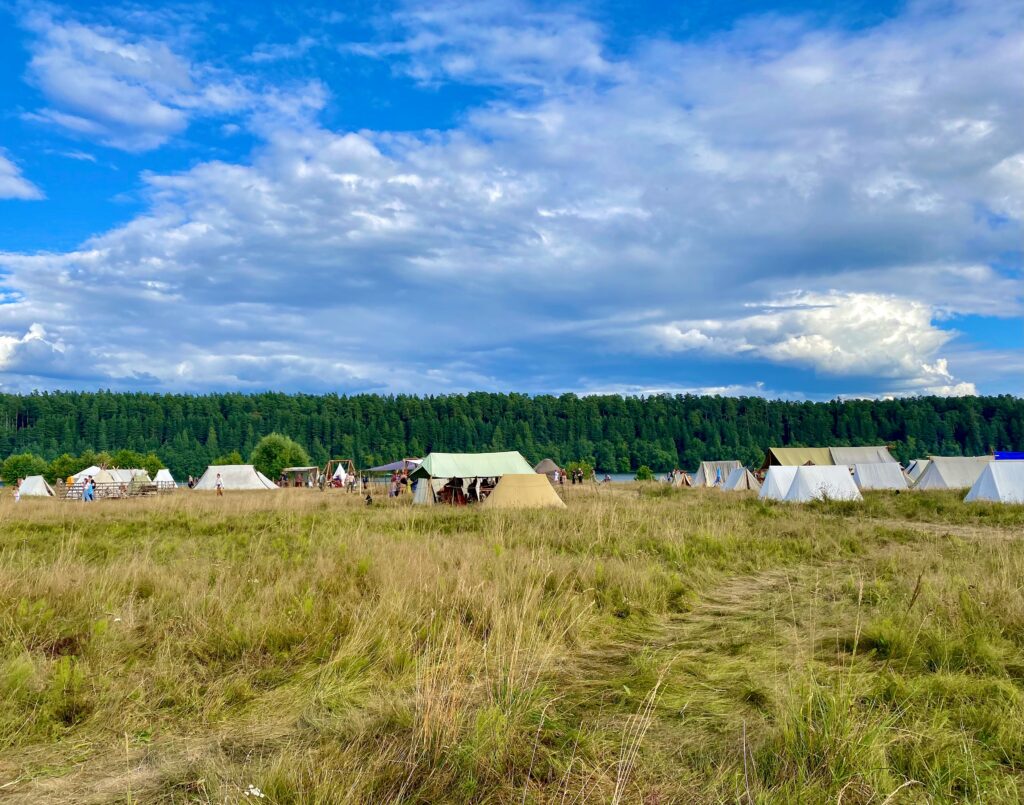 The Best Family Tents for Autumn. A field full of people camping in different tents. Photo by Max Tcvetkov on Unsplash