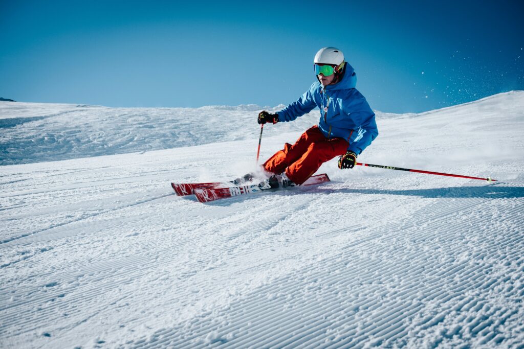 Someone skiing on a groomed run. Photo by Maarten Duineveld on Unsplash