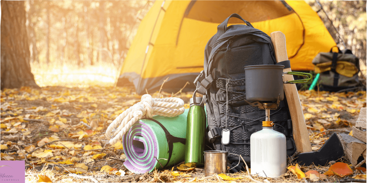 Camping gear in a wooded forest. Source: Canva