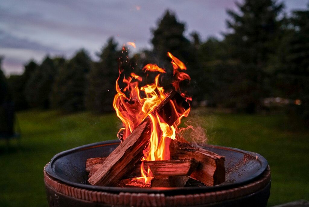 A campfire. Benefits of autumn camping. Photo by R.D. Smith on Unsplash