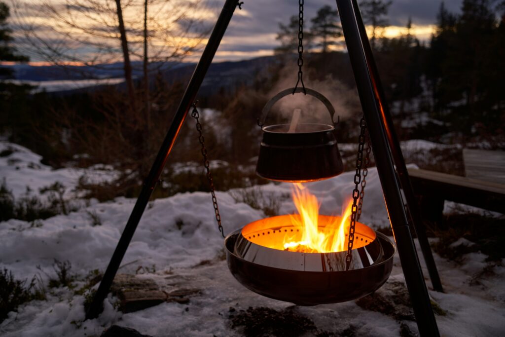 A pot heating over a campfire. Photo by Barnabas Davoti on Unsplash