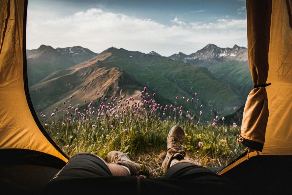 A tent opening overlooking the mountains. Photo by Dominik Jirovský on Unsplash