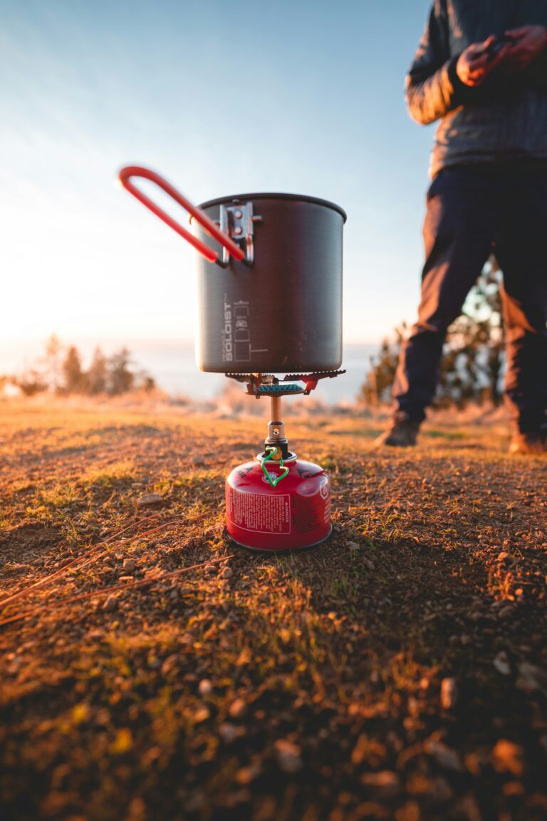 A camping stove cooking something. Photo by Will Truettner on Unsplash