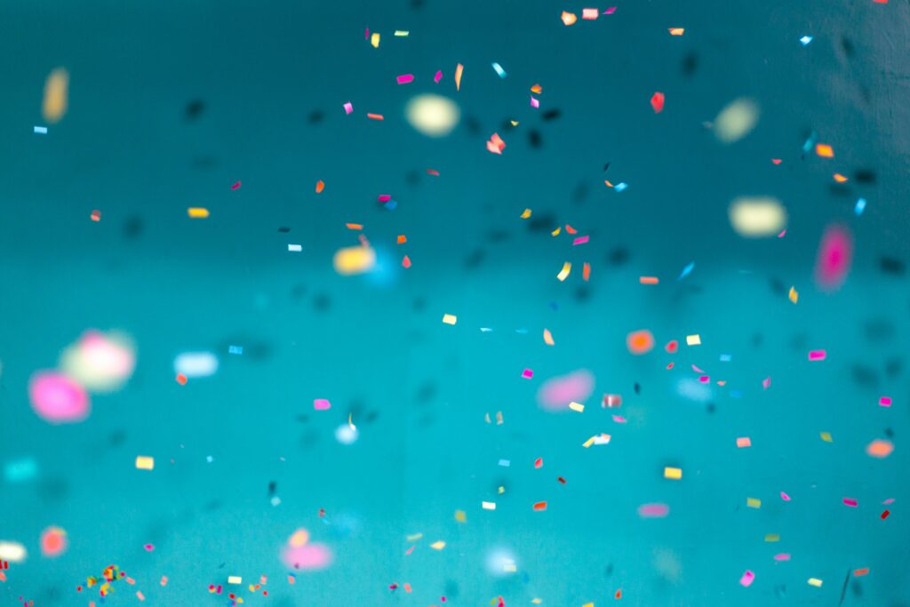 Confetti floating in the air. Photo by Jason Leung on Unsplash