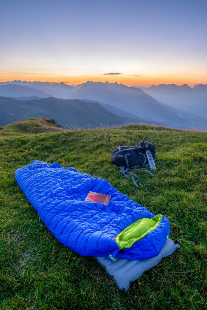 A sleeping bag on a sleeping mat outside. Photo by Felix M. Dorn on Unsplash