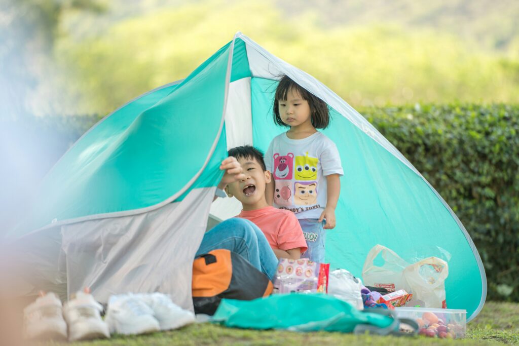 Young children in a tent. Autumn camping with toddlers. Photo by Samuel Chan on Unsplash
