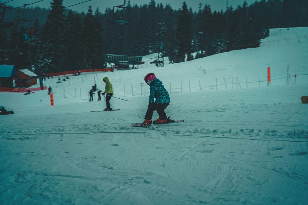 A child learning to ski. Photo by Lumière Rezaie on Unsplash