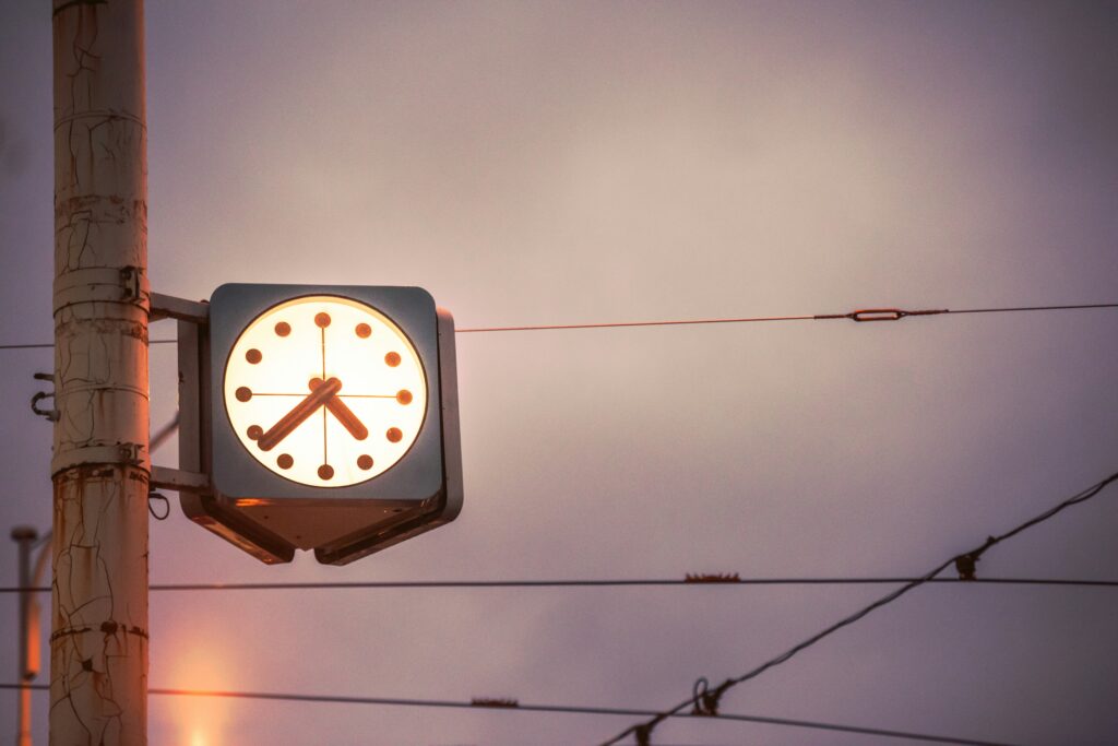 A clock just after 4:35 pm with the fading light. Photo by Ondrej Supitar on Unsplash