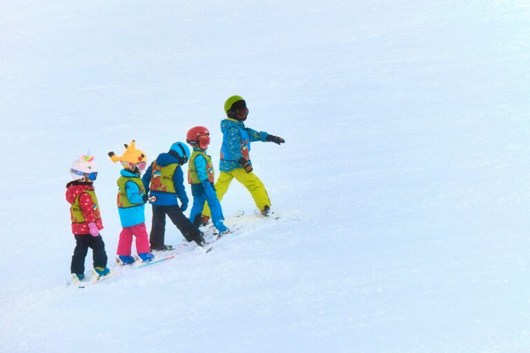 Kids skiing on a mountain. Photo by Maxwell Ingham on Unsplash