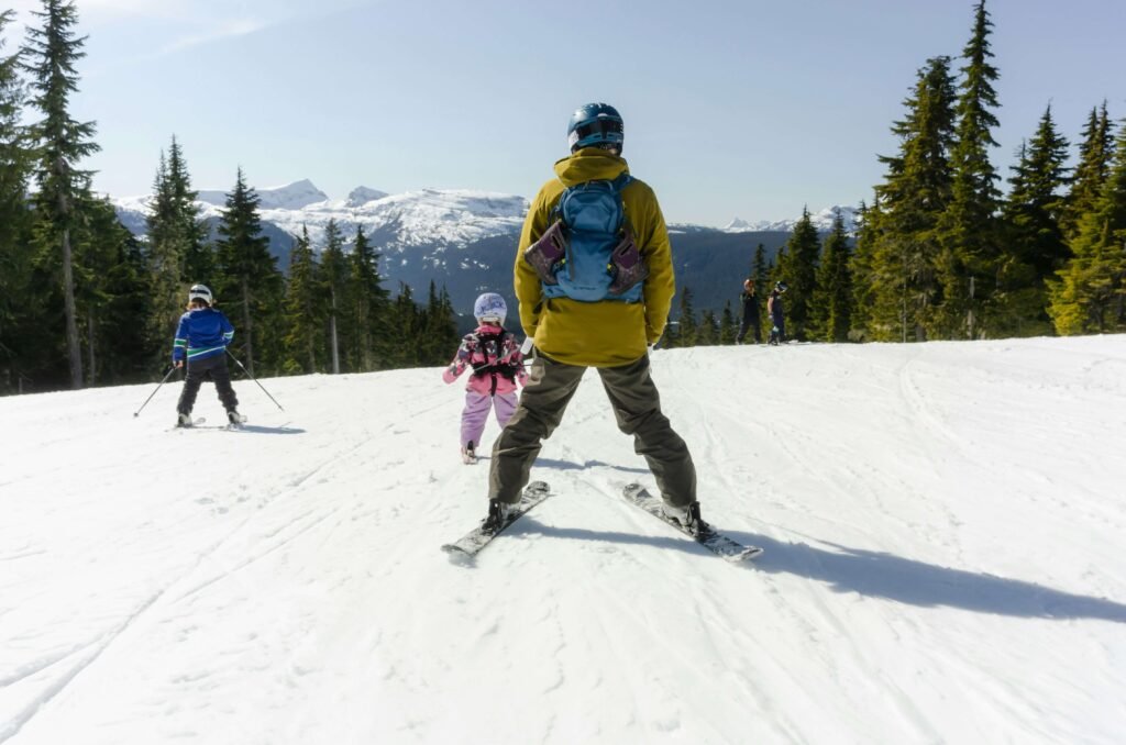 A young family skiing together. Photo by Greg Rosenke on Unsplash