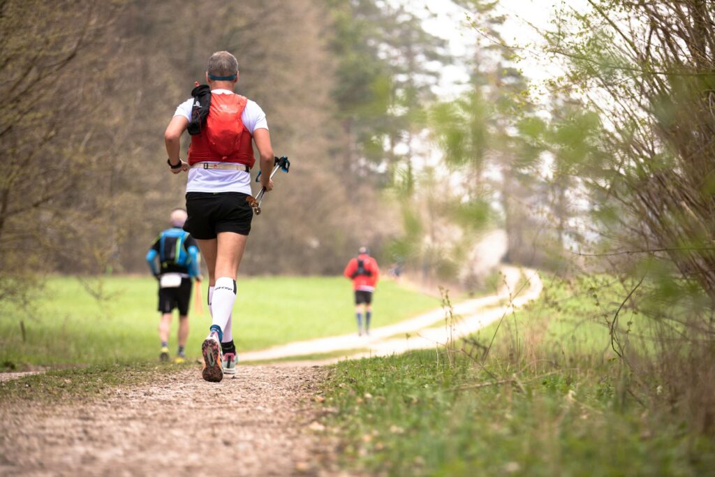 Trail runners in a race along a scenic route. Photo by Markus Spiske on Unsplash