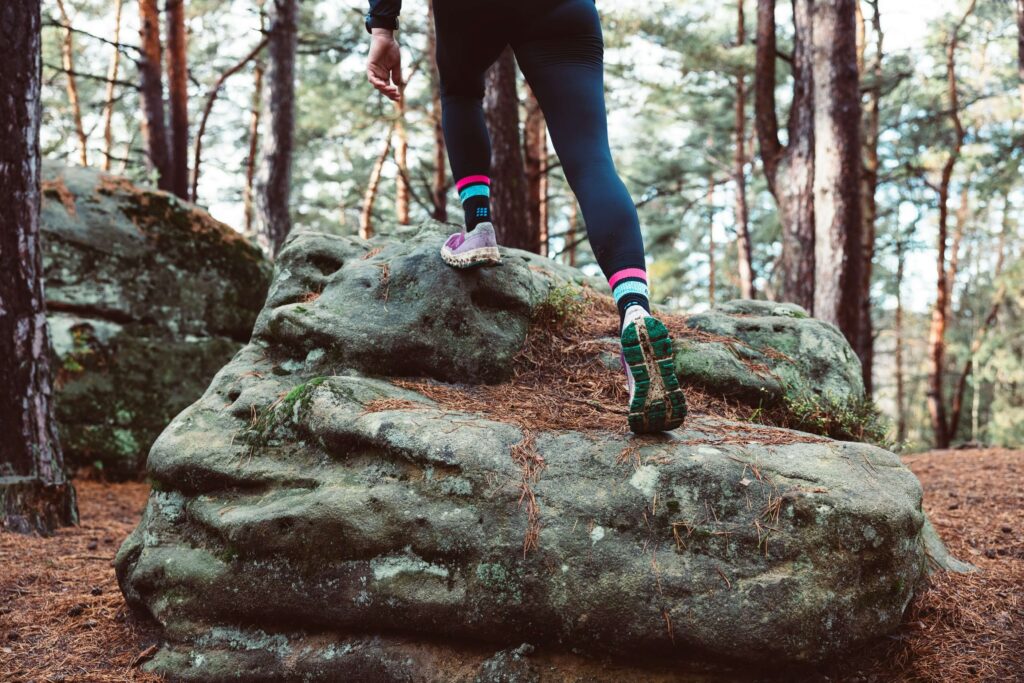 Running motivation. Someone running over stones through a forest. Photo by Markus Spiske on Unsplash