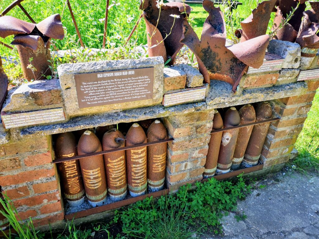 Old ammunition on display at Tyneham Farm with information plaques about the D-Day landings in 1944. Source: Rebecca Campbell Ltd