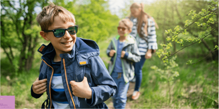 Two young boys and a parent going on a summer nature walk. Source: Canva