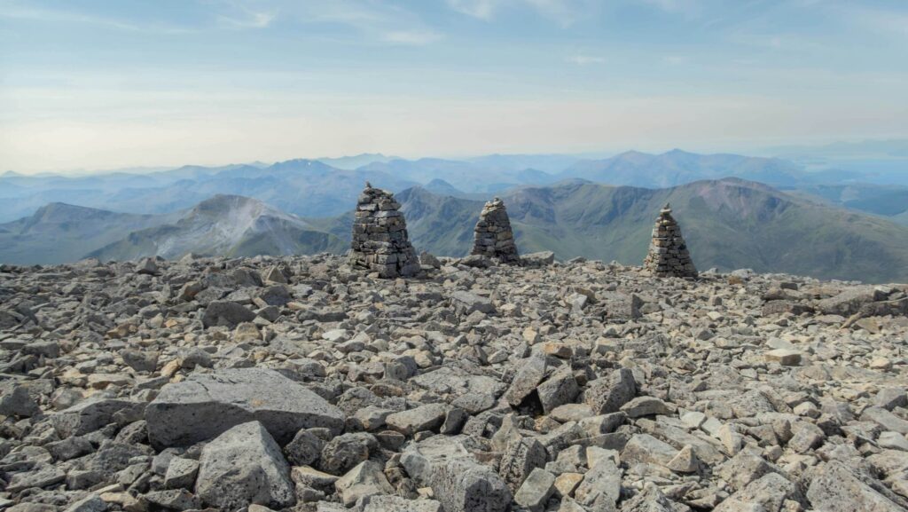The summit of Ben Nevis with the three cairns marking the top. Photo by Ray Harrington on Unsplash